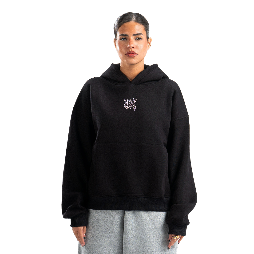 Person wearing a black hoodie with a logo on a white background