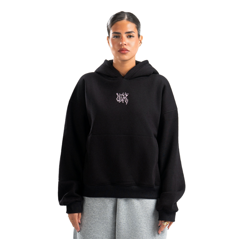 Person wearing a black hoodie with a logo on a white background