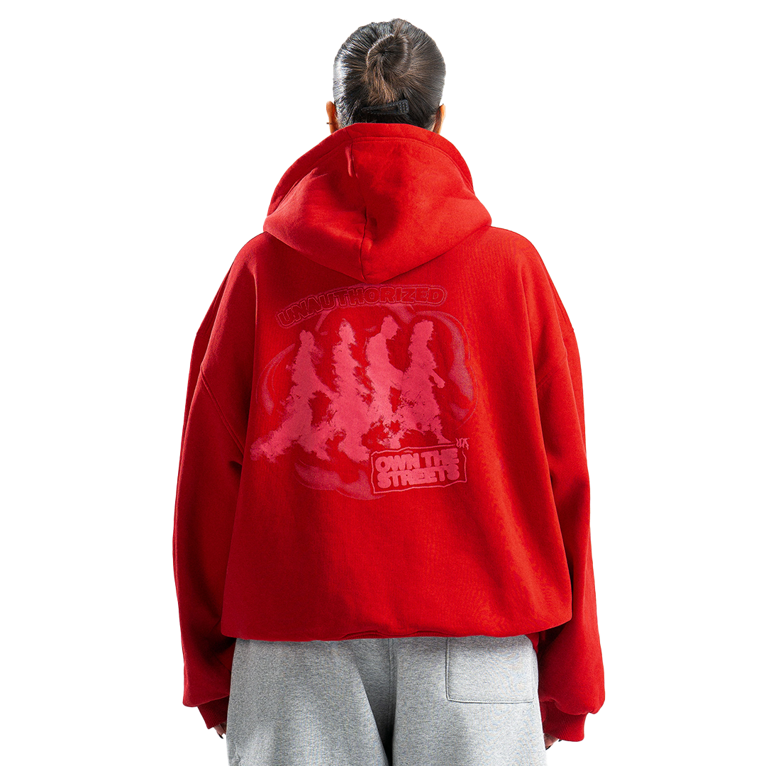 Person wearing a red hoodie with a graphic design on the back, standing against a white background